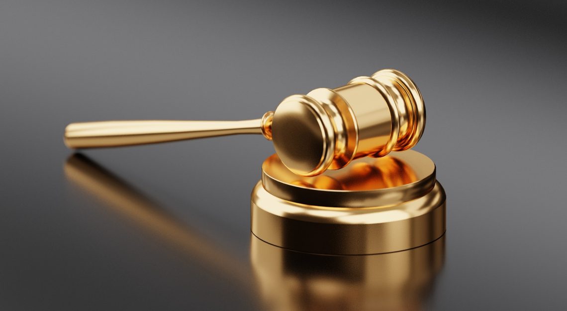 Golden gavel resting on tabletop