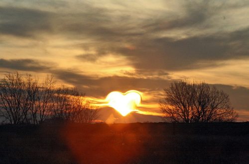 A sunset with the sun in the shape of a heart