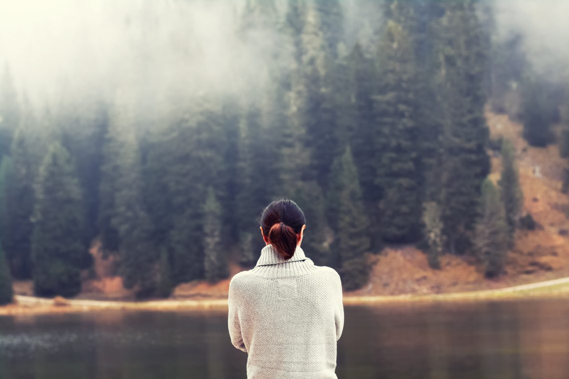 Woman looking at a river and landscape