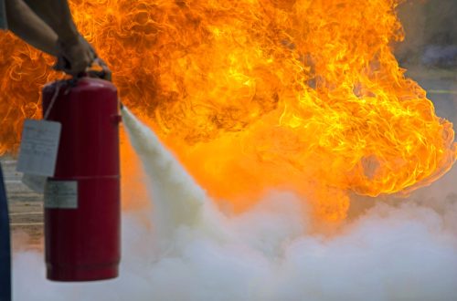 A man practices how to use a fire-extinguisher
