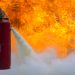 A man practices how to use a fire-extinguisher