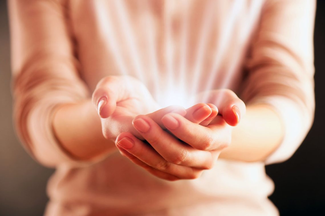 Female hands on dark background