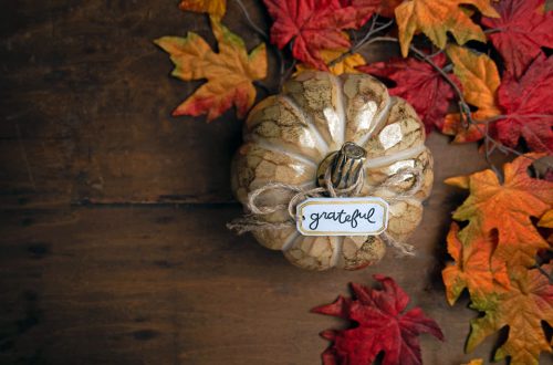 Wooden pumpkin with small tag that says Grateful
