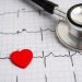 Stethoscope on electrocardiogram ECG with red heart