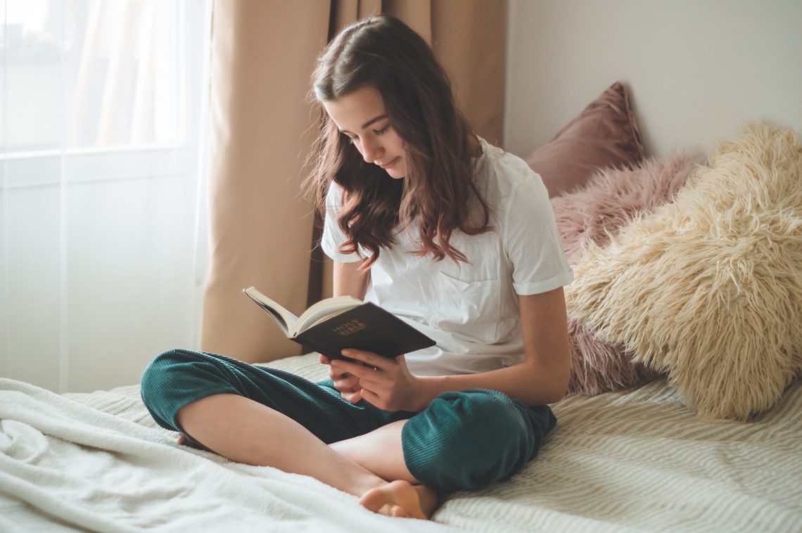 Teenage girl reading the Bible