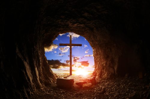 Inside an empty tomb looking outside to the cross