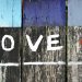 A fence with the word "love" painted on it