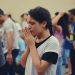 A group of young people praying