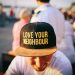 A man wearing a ball cap that says, "Love Your Neighbour"