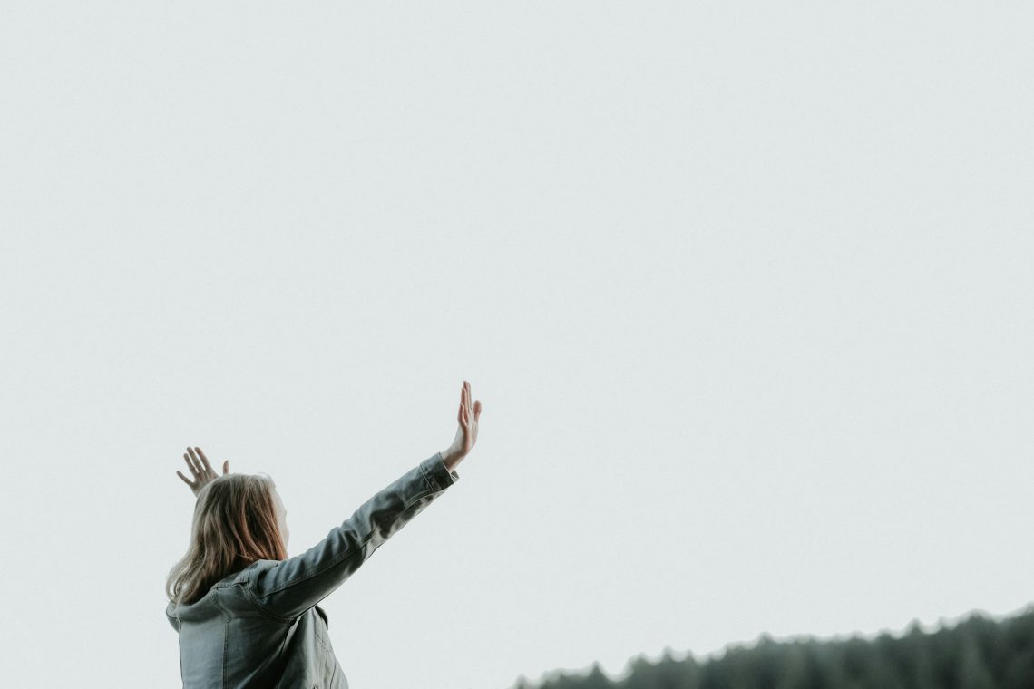 A woman worshiping God outside