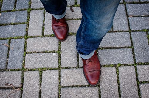 View of a man's shoes as he steps forward