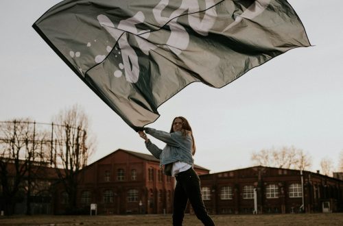 A woman is waving a flag that says "Jesus"