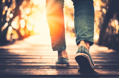 Woman walking over a bridge