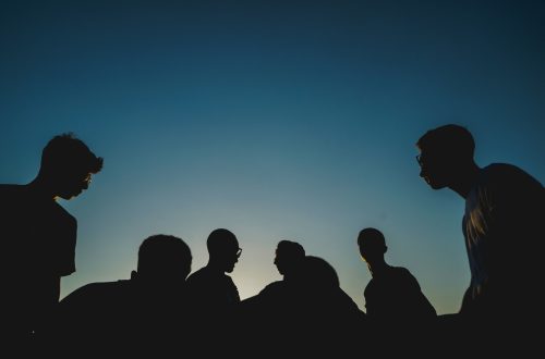 A group of youth in front of a night sky