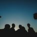 A group of youth in front of a night sky