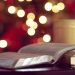 Bible and mug in front of Christmas lights
