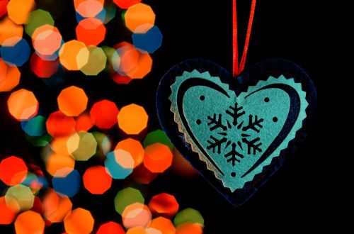 Heart Ornament in front of Christmas Lights