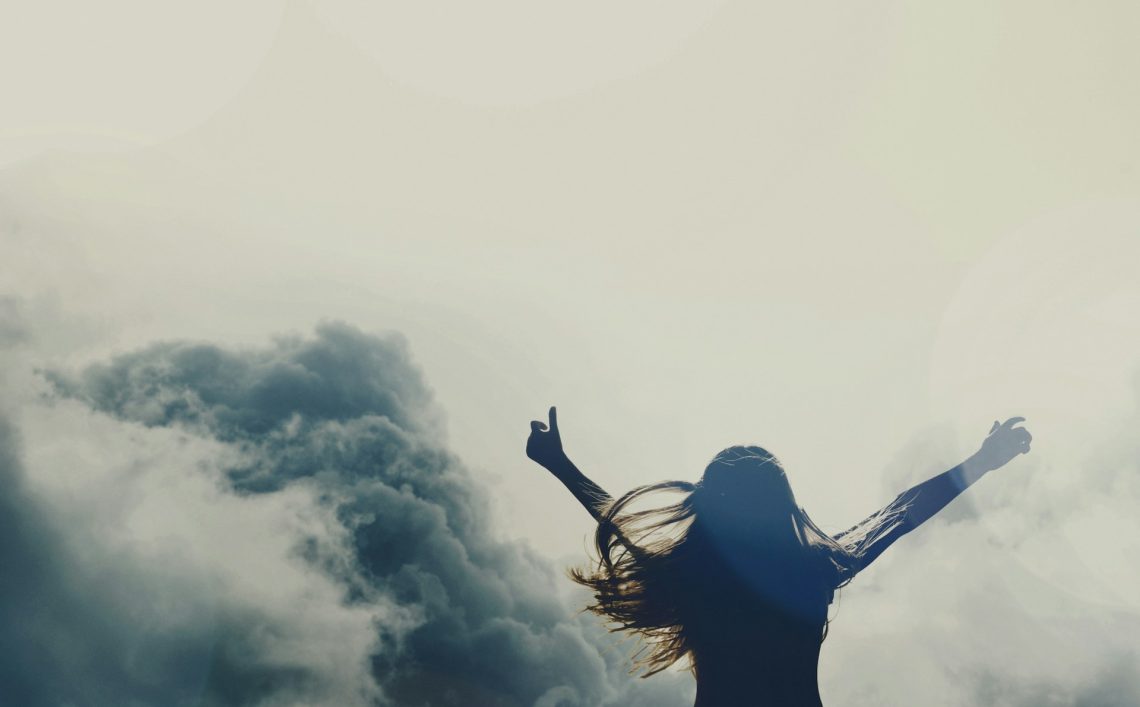 A woman raising her arms to heaven