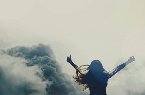 A woman raising her arms to heaven