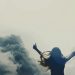 A woman raising her arms to heaven