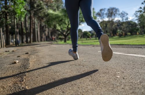A woman running in a park on the pavement