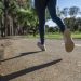 A woman running in a park on the pavement
