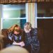Two women with heads bowed and praying