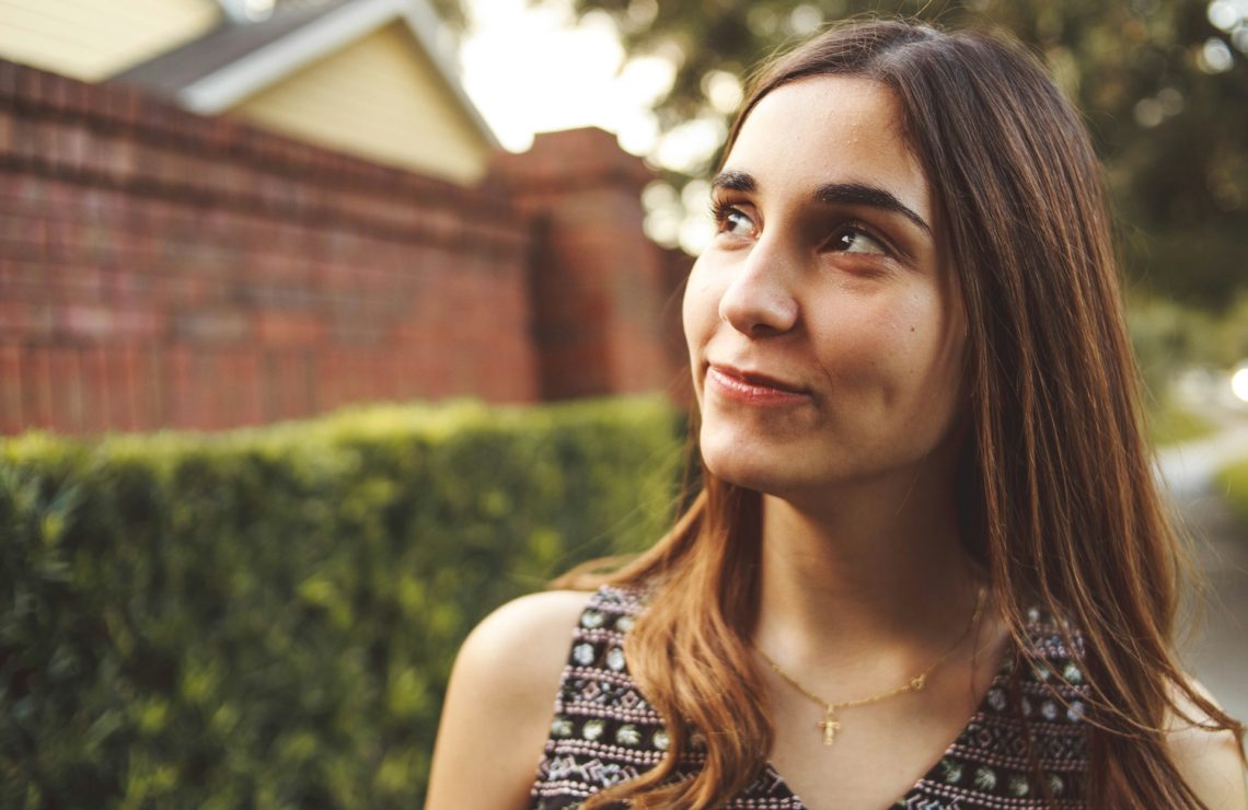 A woman looking up to the sky and smiling
