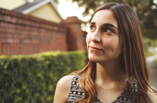 A woman looking up to the sky and smiling