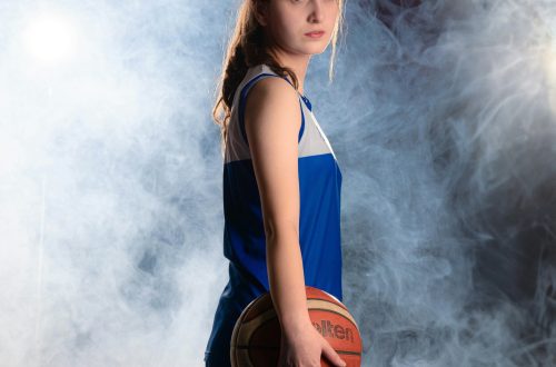 Young lady standing with a basketball