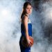 Young lady standing with a basketball