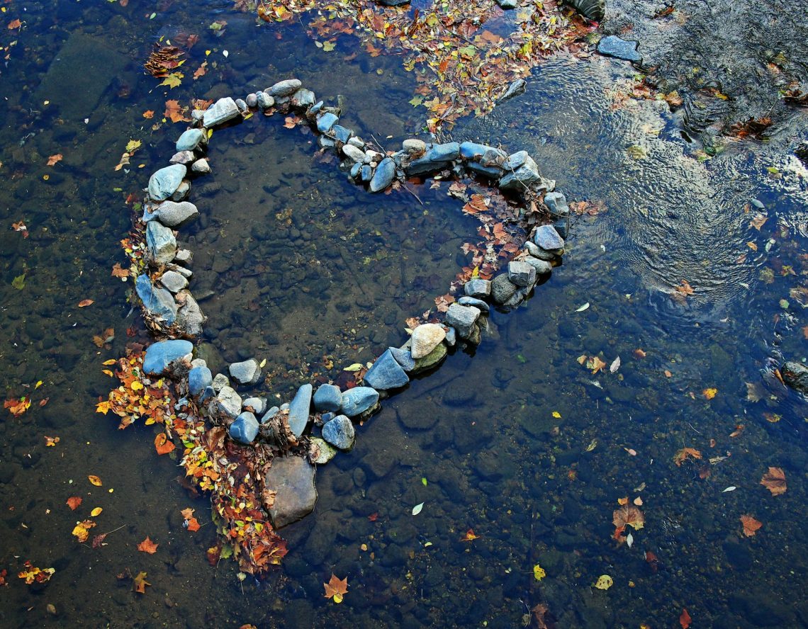 A heart made out of rocks in a creek