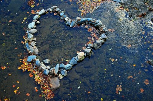 A heart made out of rocks in a creek