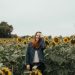 Woman standing in a sunflower field