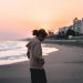 Woman looking down and walking on the beach