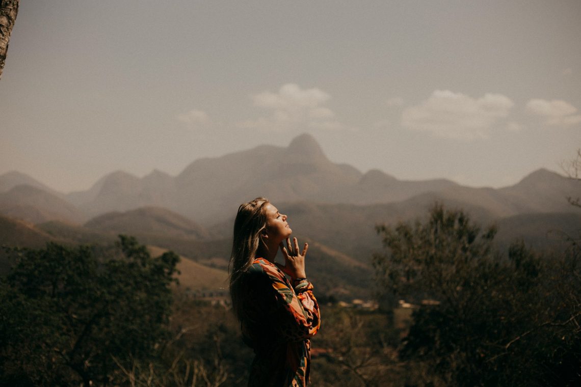 Woman praying in the mountains
