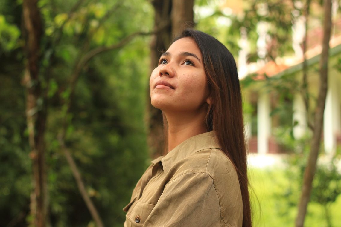 Young woman looking up