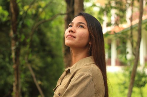 Young woman looking up