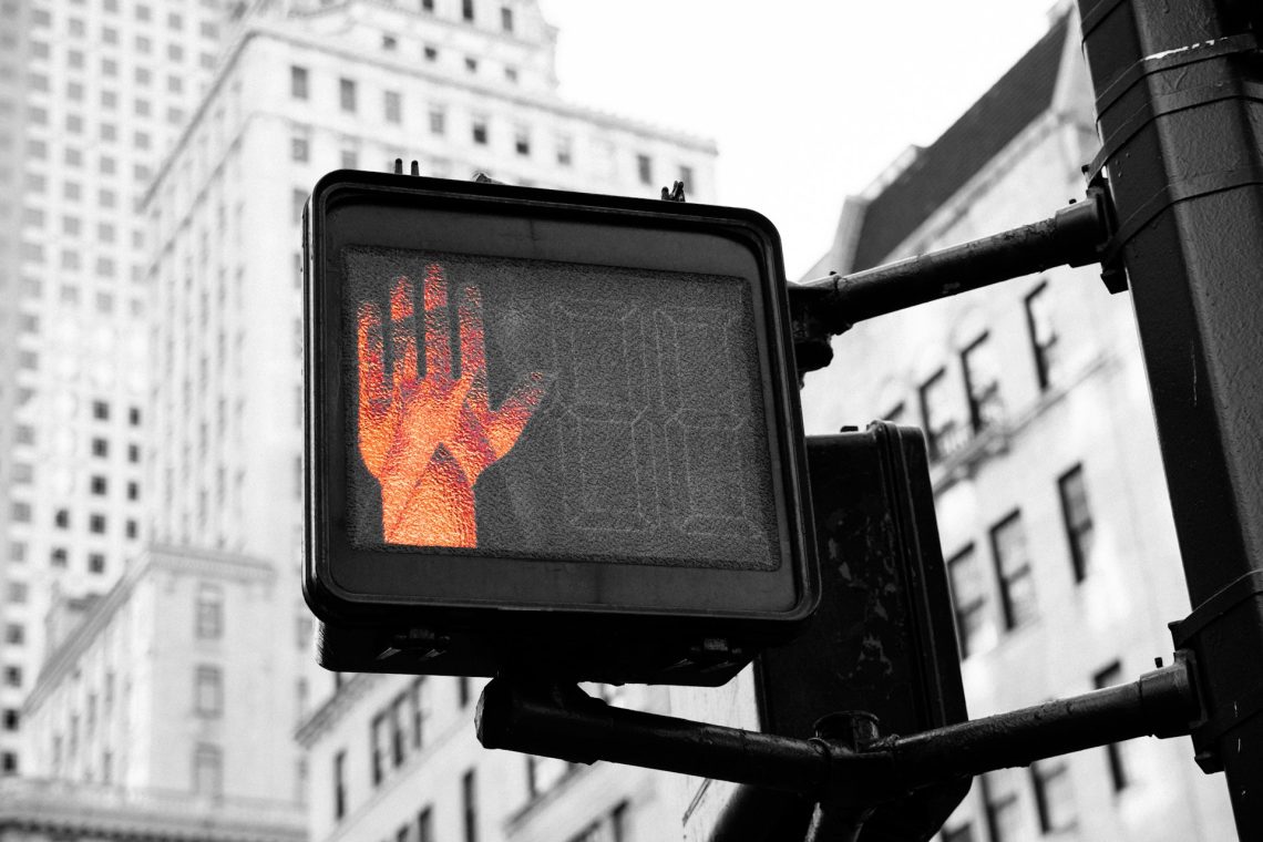 Pedestrian crosswalk light showing a don't walk sign