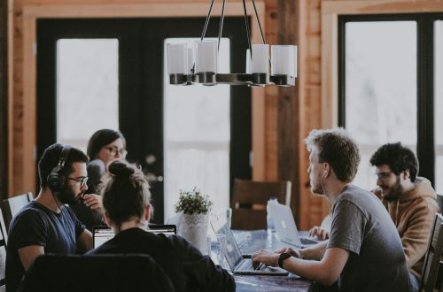 A group of people sit around a table to work