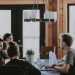 A group of people sit around a table to work