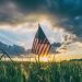 American flag on meadow at sunrise